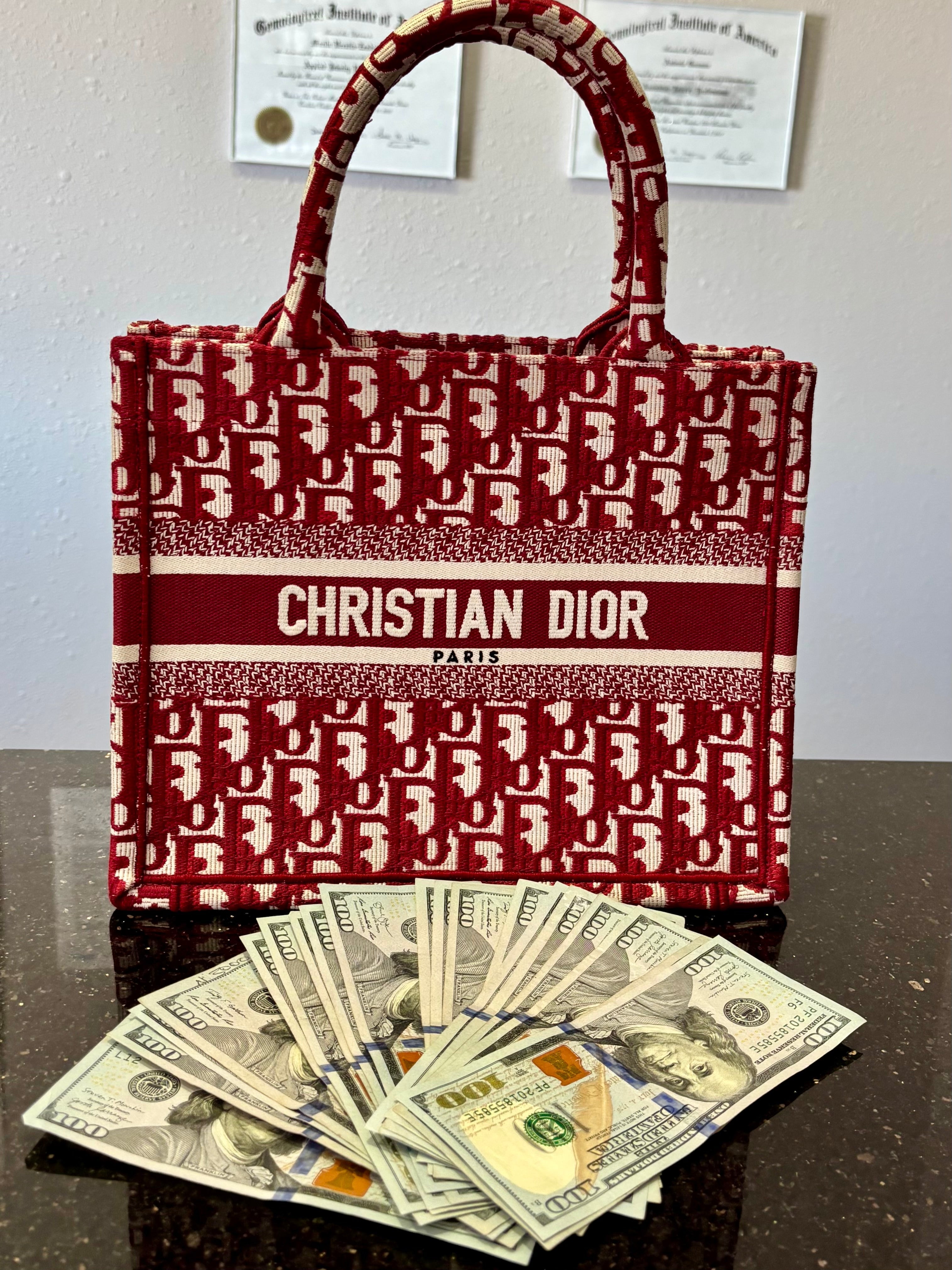 Christian Dior Used bag red with money in front of it